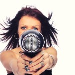 portrait of beautiful young woman with fashion hairstyle holding hairdryer